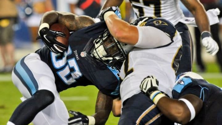 Aug 23, 2015; Nashville, TN, USA; Tennessee Titans defensive back Will Brown (32) is tackled by St. Louis Rams defensive tackle Louis Trinca-Pasat (62) during the second half at Nissan Stadium. Titans won 27-14. Mandatory Credit: Jim Brown-USA TODAY Sports