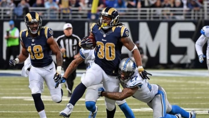 Dec 13, 2015; St. Louis, MO, USA; St. Louis Rams running back Todd Gurley (30) breaks the tackle of Detroit Lions free safety Glover Quin (27) during the second half at the Edward Jones Dome. The St. Louis Rams defeat the Detroit Lions 21-14. Mandatory Credit: Jasen Vinlove-USA TODAY Sports