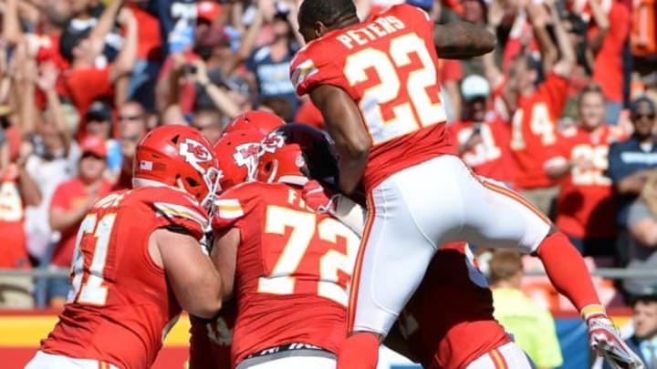 Sep 11, 2016; Kansas City, MO, USA; Kansas City Chiefs quarterback Alex Smith (11) is congratulated after scoring the winning touchdown in overtime against the San Diego Chargers at Arrowhead Stadium. Kansas City won 33-27. Mandatory Credit: John Rieger-USA TODAY Sports