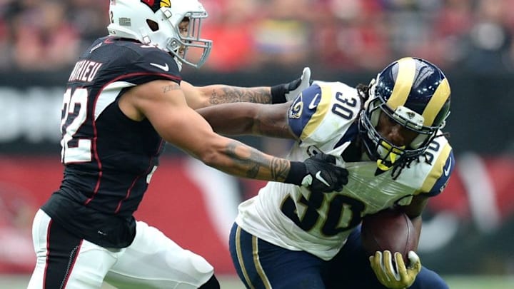 Oct 2, 2016; Glendale, AZ, USA; Arizona Cardinals free safety Tyrann Mathieu (32) attempts to tackle Los Angeles Rams running back Todd Gurley (30) during the second half at University of Phoenix Stadium. The Rams won 17-13. Mandatory Credit: Joe Camporeale-USA TODAY Sports