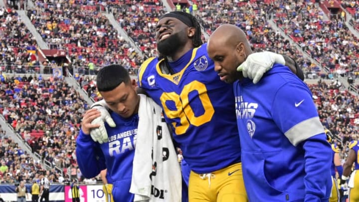 LOS ANGELES, CA - DECEMBER 29: Michael Brockers #90 of the Los Angeles Rams is helped off the field after an injury while playing the Arizona Cardinals in the second half at Los Angeles Memorial Coliseum on December 29, 2019 in Los Angeles, California. (Photo by John McCoy/Getty Images)