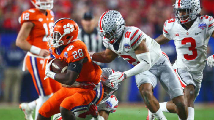 December 31, 2016; Glendale, AZ, USA; Ohio State Buckeyes cornerback Marshon Lattimore (2) tackles Clemson Tigers running back Tavien Feaster (28) in the 2016 CFP semifinal at University of Phoenix Stadium. Mandatory Credit: Mark J. Rebilas-USA TODAY Sports