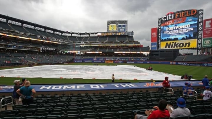 Jul 25, 2016; New York City, NY, USA; Fans make their way to the exits after the game between the St. Louis Cardinals and the New York Mets was postponed due to rain at Citi Field. Mandatory Credit: Adam Hunger-USA TODAY Sports