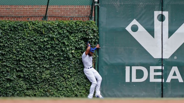 CHICAGO, IL - JULY 20: Jason Heyward #22 of the Chicago Cubs collides with the outfield wall while trying to catch the three run home run ball of Matt Carpenter #13 of the St. Louis Cardinals (not pictured) at Wrigley Field on July 20, 2018 in Chicago, Illinois. (Photo by Jon Durr/Getty Images)