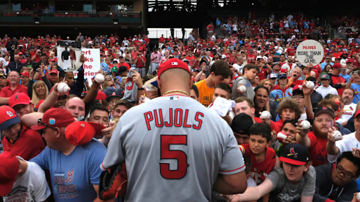 Albert Pujols (5) signs autographs prior to his first game back at Busch Stadium against the St. Louis Cardinals. Mandatory Credit: Jeff Curry-USA TODAY Sports