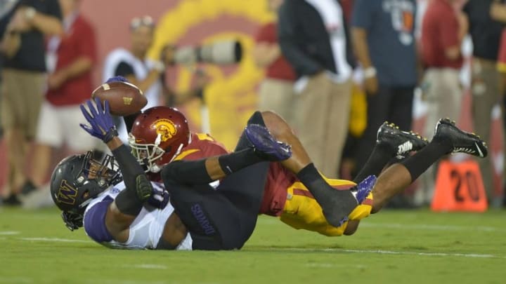 Oct 8, 2015; Los Angeles, CA, USA; Washington Huskies tight end Joshua Perkins (82) is defended by Southern California Trojans safety Marvell Tell III (7) at Los Angeles Memorial Coliseum. Mandatory Credit: Kirby Lee-USA TODAY Sports