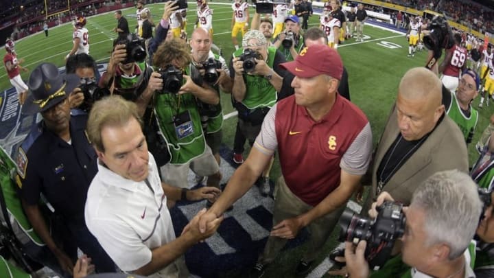 Sep 3, 2016; Arlington, TX, USA; Alabama Crimson Tide head coach Nick Saban (left) shakes hands with USC Trojans head coach Clay Helton (right) after the game at AT&T Stadium. Mandatory Credit: Kirby Lee-USA TODAY Sports