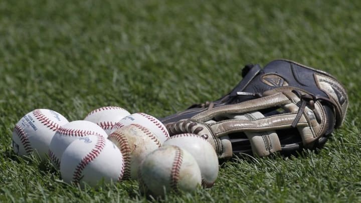 Jul 4, 2014; Pittsburgh, PA, USA; MLB baseballs and a glove sit on the field prior to the Pittsburgh Pirates against the Philadelphia Phillies at PNC Park. Mandatory Credit: Charles LeClaire-USA TODAY Sports