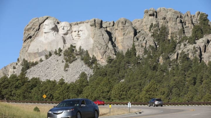 KEYSTONE, SD - OCTOBER 01: Cars travel along the highway near the entrance to Mount Rushmore National Memorial on October 1, 2013 in Keystone, South Dakota. Mount Rushmore and all other national parks were closed today after congress failed to pass a temporary funding bill, forcing about 800,000 federal workers off the job. A bulletin issued by the Department of Interior states, "Effective immediately upon a lapse in appropriations, the National Park Service will take all necessary steps to close and secure national park facilities and grounds in order to suspend all activities ...Day use visitors will be instructed to leave the park immediately..." (Photo by Scott Olson/Getty Images)