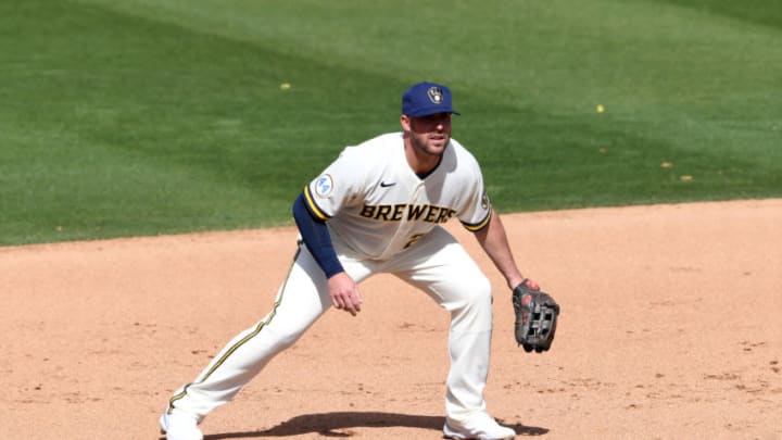 PHOENIX, ARIZONA - MARCH 04: Travis Shaw #21 of the the Milwaukee Brewers gets ready to make a play against the Cleveland Indians during a spring training game at American Family Fields of Phoenix on March 04, 2021 in Phoenix, Arizona. (Photo by Norm Hall/Getty Images)