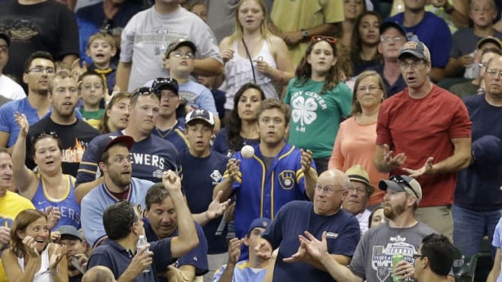 MILWAUKEE, WI - JULY 21: Fans scramble for a foul ball hit by Jean Segura #9 of the Milwaukee Brewers during the bottom of the sixth inning against the Cincinnati Reds at Miller Park on July 21, 2014 in Milwaukee, Wisconsin. (Photo by Mike McGinnis/Getty Images)