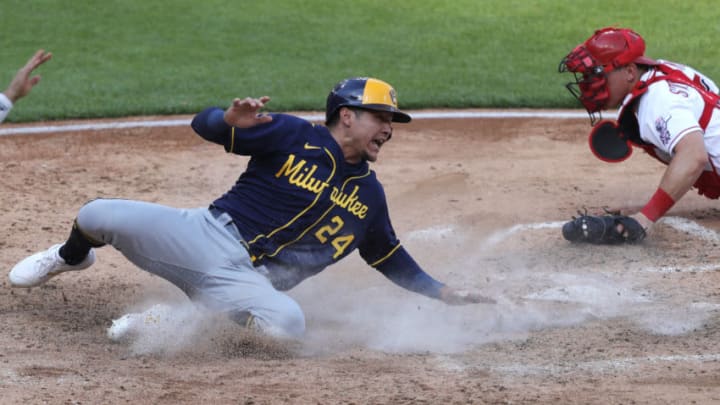 May 22, 2021; Cincinnati, Ohio, USA; during the sixth Milwaukee Brewers right fielder Avisail Garcia (24) slides safely into home against Cincinnati Reds catcher Tyler Stephenson (37) during the sixth inning at Great American Ball Park. Mandatory Credit: David Kohl-USA TODAY Sports