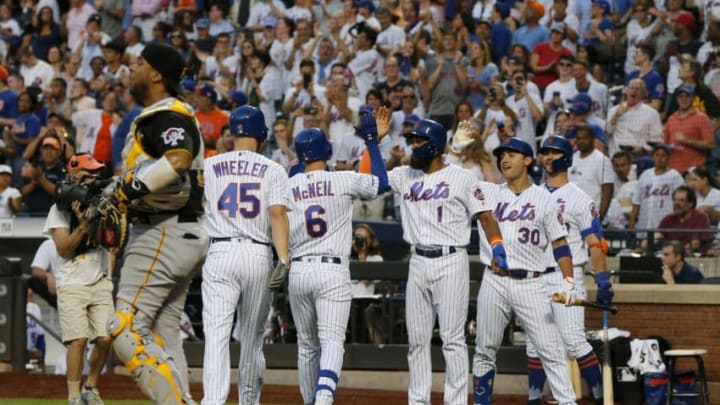 NEW YORK, NEW YORK - JULY 26: Elias Diaz #32 of the Pittsburgh Pirates looks on as Jeff McNeil #6 of the New York Mets celebrates his third inning three run home run with teammates Zack Wheeler #45, Amed Rosario #1, Michael Conforto #30 and Pete Alonso #20 at Citi Field on July 26, 2019 in New York City. (Photo by Jim McIsaac/Getty Images)