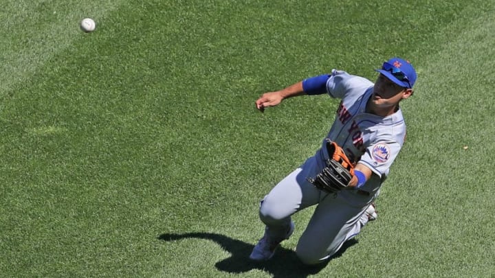 CHICAGO, ILLINOIS - AUGUST 01: Michael Conforto #30 of the New York Mets makes a sliding catch to end the 7th inning against the Chicago White Sox at Guaranteed Rate Field on August 01, 2019 in Chicago, Illinois. (Photo by Jonathan Daniel/Getty Images)