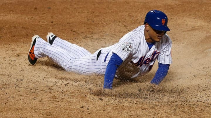 NEW YORK, NY - OCTOBER 30: Juan Lagares #12 of the New York Mets scores in the sixth inning against the Kansas City Royals during Game Three of the 2015 World Series at Citi Field on October 30, 2015 in the Flushing neighborhood of the Queens borough of New York City. (Photo by Doug Pensinger/Getty Images)