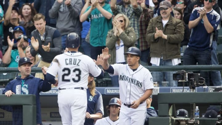 SEATTLE, WA - SEPTEMBER 23: Nelson Cruz #23 of the Seattle Mariners is greeted at the dugout after scoring on a double by Kyle Seager #15 in the sixth inning at Safeco Field on September 23, 2017 in Seattle, Washington. (Photo by Lindsey Wasson/Getty Images)