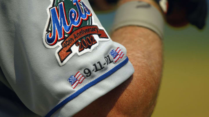ATLANTA - SEPTEMBER 11: A member of the New York Mets wears a jersey commemorating the 40th anniversary of the club and the first anniversary of the terror attacks of 2001 during the first game of a MLB double-header against the Atlanta Braves on September 11, 2002 at Turner Field in Atlanta, Georgia. The Braves won 8-5. (Photo by Jamie Squire/Getty Images)