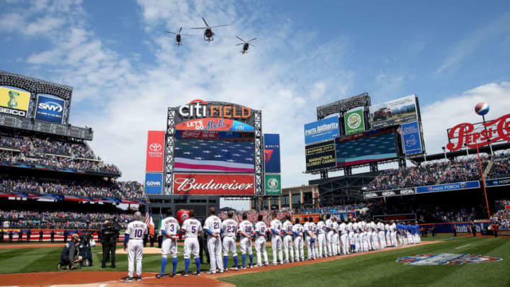 NEW YORK, NY - APRIL 13: The New York Mets line up for the national anthem before the start of their Opening Day game against the Philadelphia Phillies on April 13, 2015 at Citi Field in the Flushing neighborhood of the Queens borough of New York City. (Photo by Elsa/Getty Images)