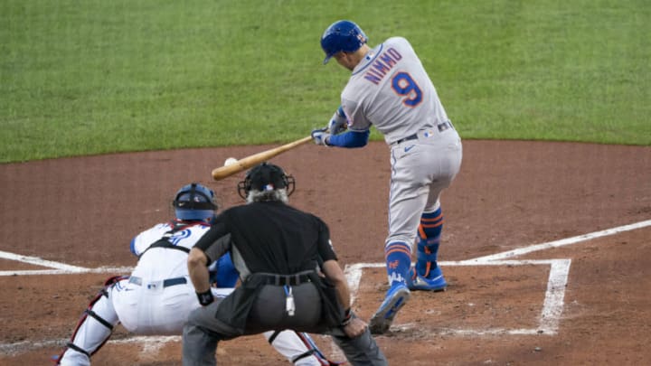 Sep 11, 2020; Buffalo, New York, USA; New York Mets center fielder Brandon Nimmo (9) hits a single during the third inning against the Toronto Blue Jays at Sahlen Field. Mandatory Credit: Gregory Fisher-USA TODAY Sports
