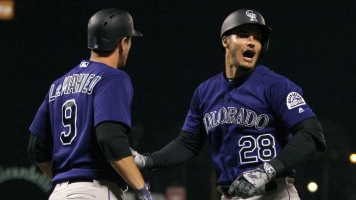 Jul 5, 2016; San Francisco, CA, USA; Colorado Rockies third baseman Nolan Arenado (28) right is greeted at home plate by second baseman D.J. LeMahieu (9) after Arenado three run homer in the seventh inning of their MLB baseball game with the San Francisco Giants at AT&T Park. Mandatory Credit: Lance Iversen-USA TODAY Sports