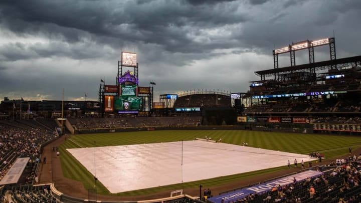 Jul 19, 2016; Denver, CO, USA; The infield tarp is pulled out during a weather delay at Coors Field prior to the game between the Colorado Rockies and the Tampa Bay Rays. Mandatory Credit: Isaiah J. Downing-USA TODAY Sports