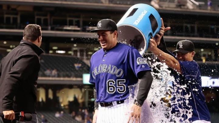 Aug 29, 2016; Denver, CO, USA; Colorado Rockies right fielder Stephen Cardullo (65) is doused with water by teammates after a game against the Los Angeles Dodgers at Coors Field. The Rockies defeated the Dodgers 8-1. Mandatory Credit: Isaiah J. Downing-USA TODAY Sports
