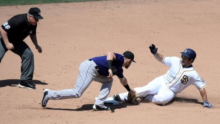 May 4, 2016; San Diego, CA, USA; San Diego Padres third baseman Brett Wallace (right) slides in safely ahead of the tag from Colorado Rockies shortstop Trevor Story (middle) as umpire Bill Miller (26) watches the play during the seventh inning at Petco Park. Mandatory Credit: Jake Roth-USA TODAY Sports