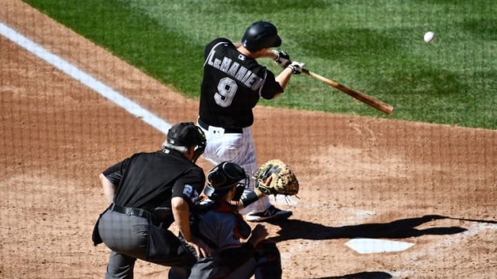 Sep 5, 2016; Denver, CO, USA; Colorado Rockies second baseman DJ LeMahieu (9) hits a sacrifice fly to score shortstop Cristhian Adames (not pictured) in the third inning against the San Francisco Giants at Coors Field. Mandatory Credit: Ron Chenoy-USA TODAY Sports