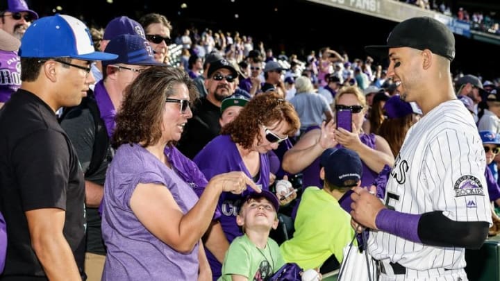 Oct 2, 2016; Denver, CO, USA; Colorado Rockies right fielder Carlos Gonzalez (5) signs autographs following the game against the Milwaukee Brewers at Coors Field. Mandatory Credit: Isaiah J. Downing-USA TODAY Sports