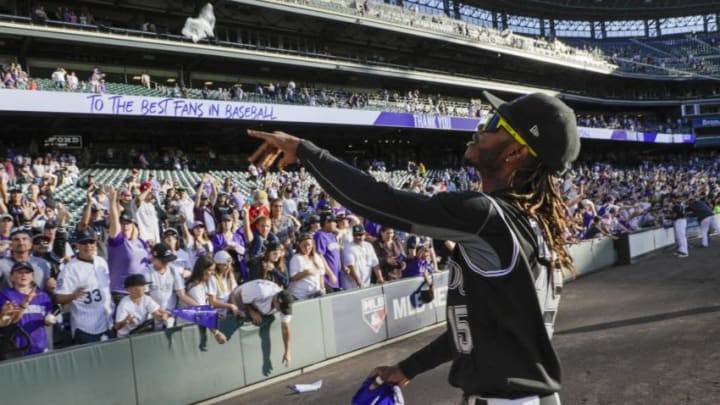 DENVER, CO - SEPTEMBER 29: Raimel Tapia #15 of the Colorado Rockies throws souvenirs to fans after the Rockies last game of the season at Coors Field on September 29, 2019 in Denver, Colorado. Colorado beat the Milwaukee Brewers 4-3 in 13 innings. (Photo by Joe Mahoney/Getty Images)