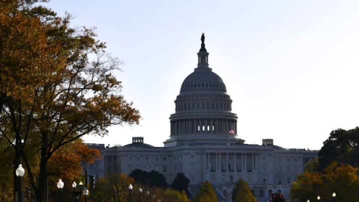 WASHINGTON, DC - NOVEMBER 13: Morning light illuminates an American flag flying at the U.S. Capitol Building on November 13, 2019 in Washington, DC. In the first public impeachment hearings in more than two decades, House Democrats are trying to build a case that President Donald Trump committed extortion, bribery or coercion by trying to enlist Ukraine to investigate his political rival in exchange for military aide and a White House meeting that Ukraine President Volodymyr Zelensky sought with Trump. (Photo by Mark Makela/Getty Images)