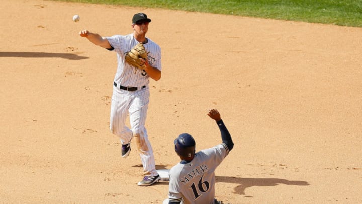 DENVER, CO - AUGUST 20: Second baseman DJ LeMahieu #9 of the Colorado Rockies throws to first base to complete the double play for the first two outs of the seventh inning as Domingo Santana #16 of the Milwaukee Brewers slides at Coors Field on August 20, 2017 in Denver, Colorado. (Photo by Justin Edmonds/Getty Images)