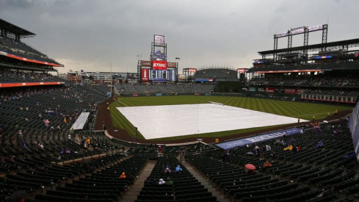 DENVER, CO - SEPTEMBER 17: The tarp sits on the field during a rain delay in the fifth inning of a regular season MLB game between the Colorado Rockies and the visiting San Diego Padres at Coors Field on September 17, 2017 in Denver, Colorado. (Photo by Russell Lansford/Getty Images) DENVER, CO - SEPTEMBER 17: The tarp sits on the field during a rain delay in the fifth inning of a regular season MLB game between the Colorado Rockies and the visiting San Diego Padres at Coors Field on September 17, 2017 in Denver, Colorado. (Photo by Russell Lansford/Getty Images)
