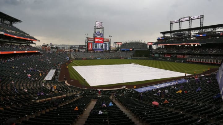 DENVER, CO - SEPTEMBER 17: The tarp sits on the field during a rain delay in the fifth inning of a regular season MLB game between the Colorado Rockies and the visiting San Diego Padres at Coors Field on September 17, 2017 in Denver, Colorado. (Photo by Russell Lansford/Getty Images)