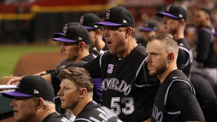 PHOENIX, AZ - MARCH 30: (R-L) Trevor Story #27, coach Ronnie Gideon #53, DJ LeMahieu #9 and hitting coach Duane Espy #58 of the Colorado Rockies watch from the dugout during the fifth inning of the MLB game against the Arizona Diamondbacks at Chase Field on March 30, 2018 in Phoenix, Arizona. (Photo by Christian Petersen/Getty Images)
