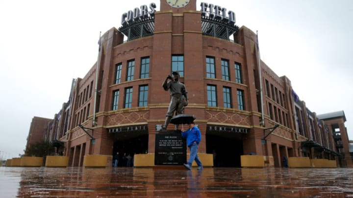 DENVER, CO - APRIL 26: A fan walks outside of Coors Field as the rain falls on April 26, 2015 in Denver, Colorado.The game between the San Francisco Giants and Colorado Rockies has been postponed due to rain. (Photo by Justin Edmonds/Getty Images)