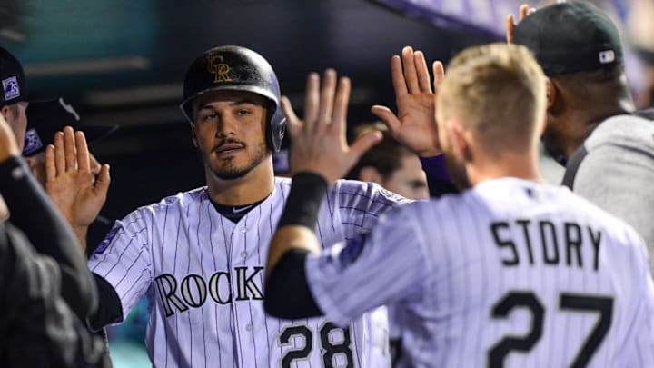 DENVER, CO - SEPTEMBER 24: Nolan Arenado #28 of the Colorado Rockies is congratulated in the dugout by Trevor Story #27 after scoring a run in the third inning of a game against the Philadelphia Phillies at Coors Field on September 24, 2018 in Denver, Colorado. (Photo by Dustin Bradford/Getty Images)