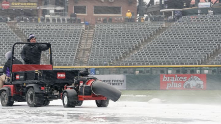 Apr 6, 2018; Denver, CO, USA; Grounds crew personnel blow snow off the infield tarp before a game between the Colorado Rockies and the Atlanta Braves at Coors Field. Mandatory Credit: Isaiah J. Downing-USA TODAY Sports