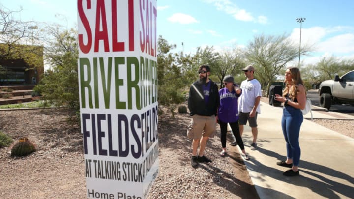 March 13, 2020; Scottsdale, AZ, USA; Jacob Saunders (white jersey) from Denver and his family stand outside Salt River Fields at Talking Stick. Saunders and family members drove from Colorado to attend a Colorado Rockies game today but Major League Baseball suspended the 2020 spring training season last night in response to the COVID-19 virus health emergency. Mandatory Credit: Rob Schumacher/The Republic via USA Today Network