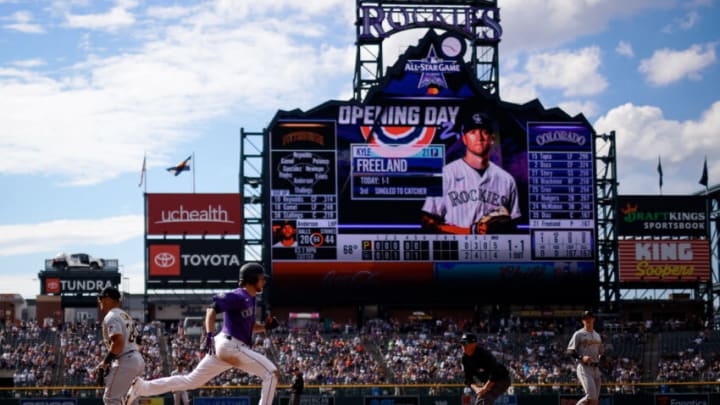 Jun 28, 2021; Denver, Colorado, USA; Colorado Rockies starting pitcher Kyle Freeland (21) outruns the throw to first in the fifth inning against the Pittsburgh Pirates at Coors Field. Mandatory Credit: Isaiah J. Downing-USA TODAY Sports