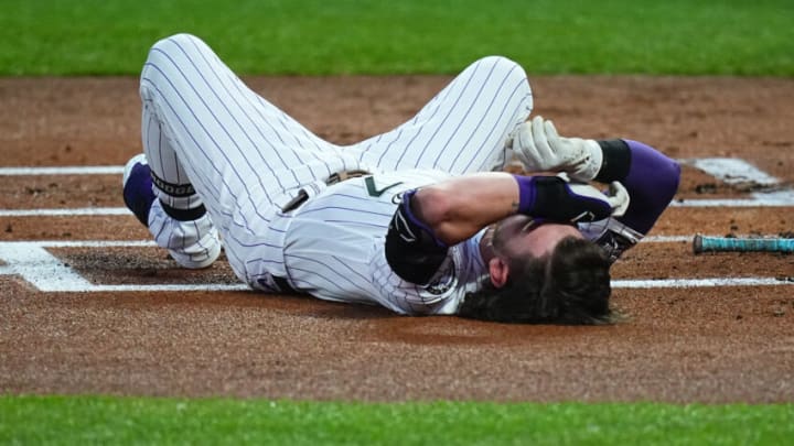 Sep 27, 2021; Denver, Colorado, USA; Colorado Rockies shortstop Brendan Rodgers (7) reacts after being hit by a baseball against the Washington Nationals in the first inning at Coors Field. Mandatory Credit: Ron Chenoy-USA TODAY Sports