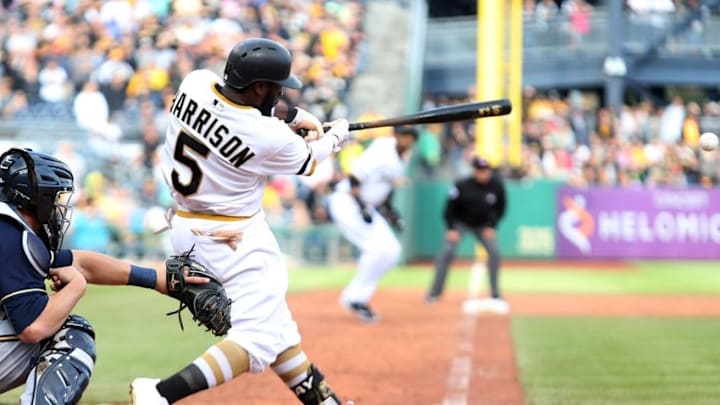 Sep 13, 2015; Pittsburgh, PA, USA; Pittsburgh Pirates left fielder Josh Harrison (5) hits a game winning RBI single against the Milwaukee Brewers during the eleventh inning at PNC Park. The Pirates won 7-6 in eleven innings. Mandatory Credit: Charles LeClaire-USA TODAY Sports