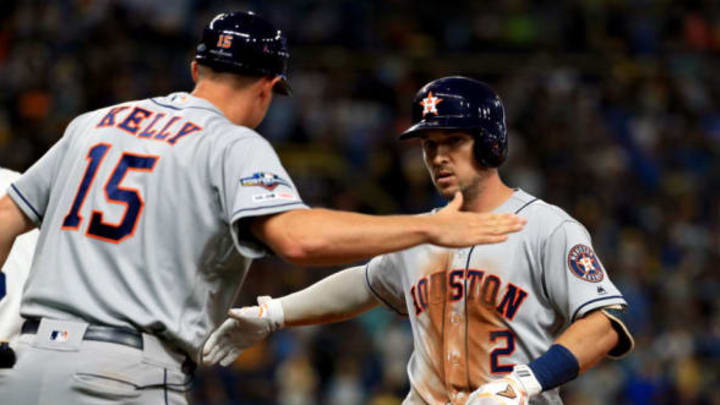 ST PETERSBURG, FLORIDA – OCTOBER 08: Alex Bregman #2 of the Houston Astros celebrates with first base coach Don Kelly #15 after hitting a single against the Tampa Bay Rays during the ninth inning in game four of the American League Division Series at Tropicana Field on October 08, 2019 in St Petersburg, Florida. (Photo by Mike Ehrmann/Getty Images)