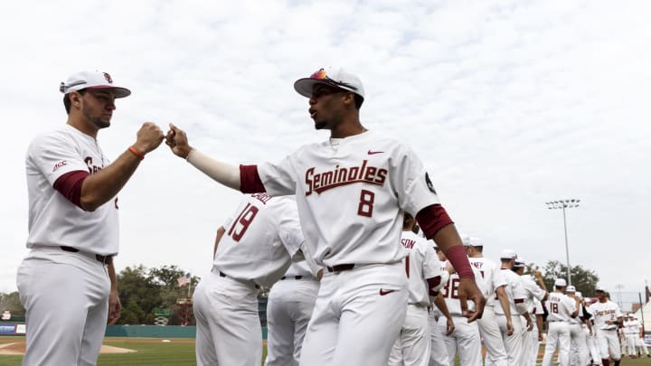 TALLAHASSEE, FL – FEBRUARY 15: Third Baseman Drew Mendoza #22 and Outfielder J.C. Flowers #8 of the Florida State Seminoles exchange hand shakes during the team’s intro before the game against the Maine Black Bears at Dick Howser Stadium on the campus of Florida State University on February 15, 2019 in Tallahassee, Florida. The 11th Ranked Florida State defeated the Maine Black Bears on Opening Day in a no-hitter 11 to 0. (Photo by Don Juan Moore/Getty Images)