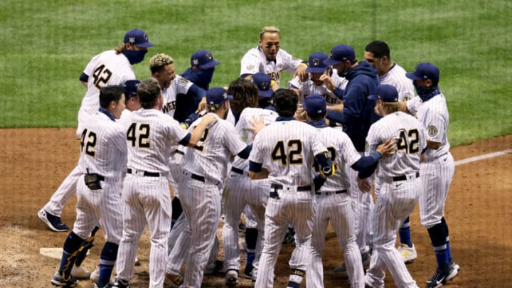 MILWAUKEE, WISCONSIN - AUGUST 29: The Milwaukee Brewers celebrate as Eric Sogard #42 hit a home run to beat the Pittsburgh Pirates 7-6 in the ninth inning at Miller Park on August 29, 2020 in Milwaukee, Wisconsin. All players are wearing #42 in honor of Jackie Robinson Day. The day honoring Jackie Robinson, traditionally held on April 15, was rescheduled due to the COVID-19 pandemic. (Photo by Dylan Buell/Getty Images)