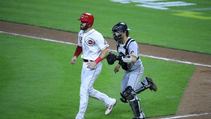 CINCINNATI, OHIO – SEPTEMBER 16: Curt Casalli #12 of the Cincinnati Reds is tagged out in a rundown by John Ryan Murphy #18 of the Pittsburgh Pirates in the fifth inning at Great American Ball Park on September 16, 2020 in Cincinnati, Ohio. (Photo by Andy Lyons/Getty Images)