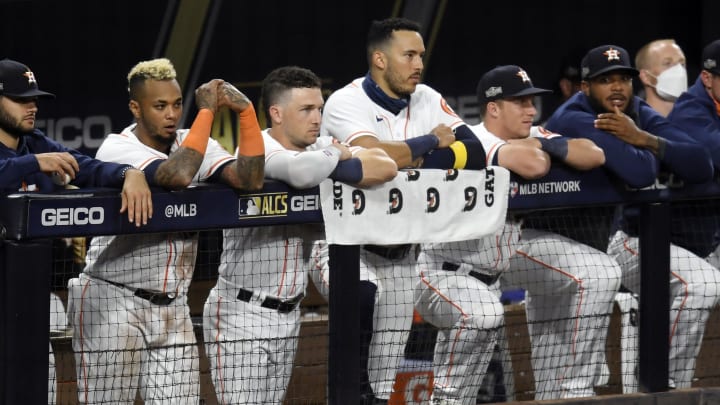 SAN DIEGO, CALIFORNIA – OCTOBER 13: Martin Maldonado #15, Alex Bregman #2 and Carlos Correa #1 of the Houston Astros look on from the dugout during the ninth inning against the Tampa Bay Rays in Game Three of the American League Championship Series at PETCO Park on October 13, 2020 in San Diego, California. (Photo by Harry How/Getty Images)