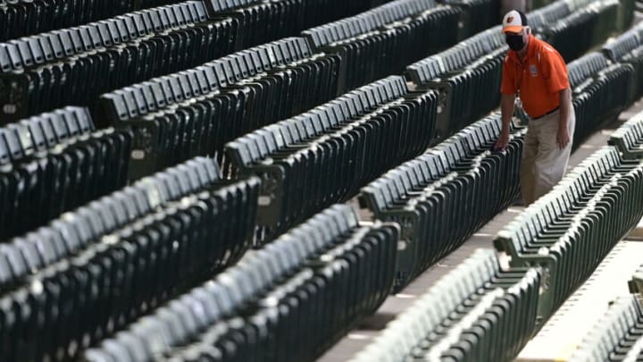 SARASOTA, FLORIDA - MARCH 15: General view of a stadium employee disinfecting the seats prior to the game between the Pittsburgh Pirates and the Baltimore Orioles during a spring training game at Ed Smith Stadium on March 15, 2021 in Sarasota, Florida. (Photo by Douglas P. DeFelice/Getty Images)