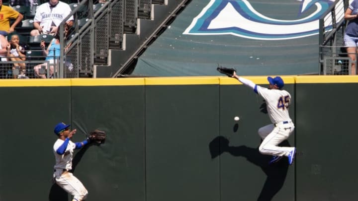 SEATTLE, WA - JULY 28: Kristopher Negron #45 of the Seattle Mariners overruns a double hit by Christin Stewart #14 of the Detroit Tigers as Mallex Smith #0 looks on in the seventh inning at T-Mobile Park on July 28, 2019 in Seattle, Washington. (Photo by Lindsey Wasson/Getty Images)