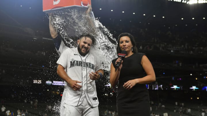 SEATTLE, WASHINGTON - AUGUST 11: Luis Torrens #22 of the Seattle Mariners gets a Gatorade shower after hitting a walk-off RBI single to win the game in the ninth inning against the Texas Rangers at T-Mobile Park on August 11, 2021 in Seattle, Washington. The Mariners won 2-1. (Photo by Alika Jenner/Getty Images)